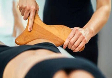 Realizando tratamiento de madera terapia en piernas. Tu centro de estética avanzada en Alicante